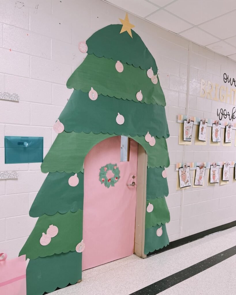 A classroom door decorated with green scalloped paper to resemble a large Christmas tree.