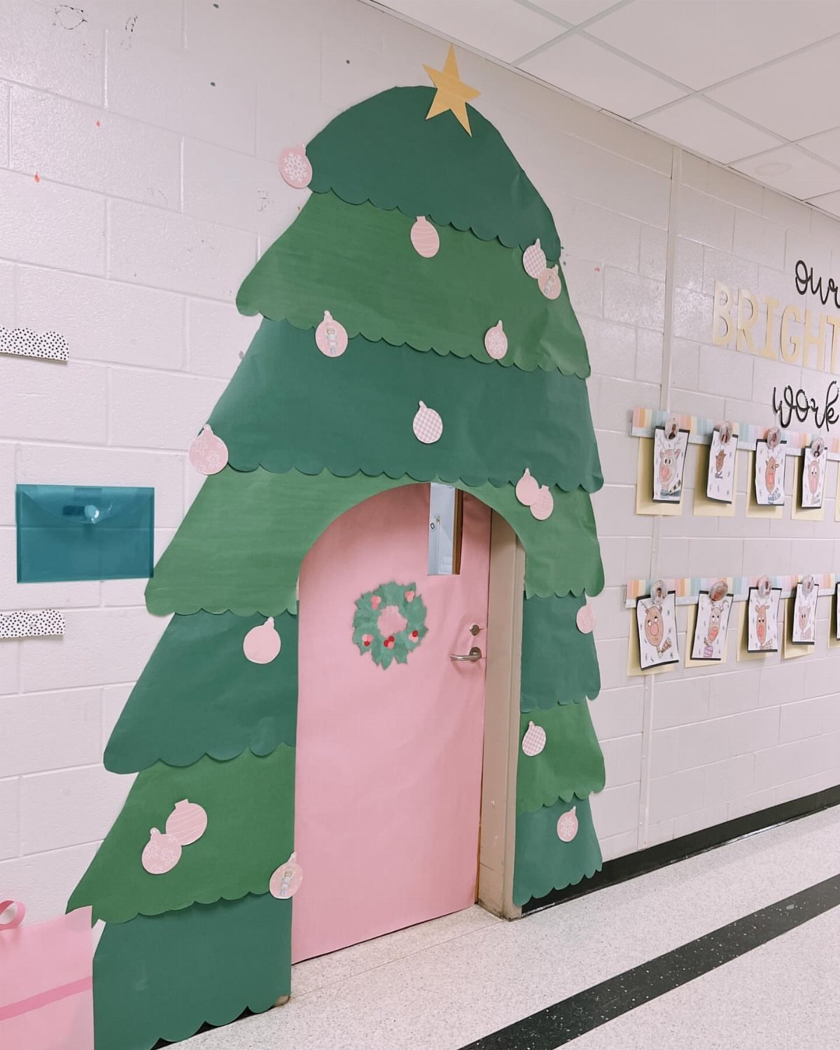 A classroom door decorated with green scalloped paper to resemble a large Christmas tree.
