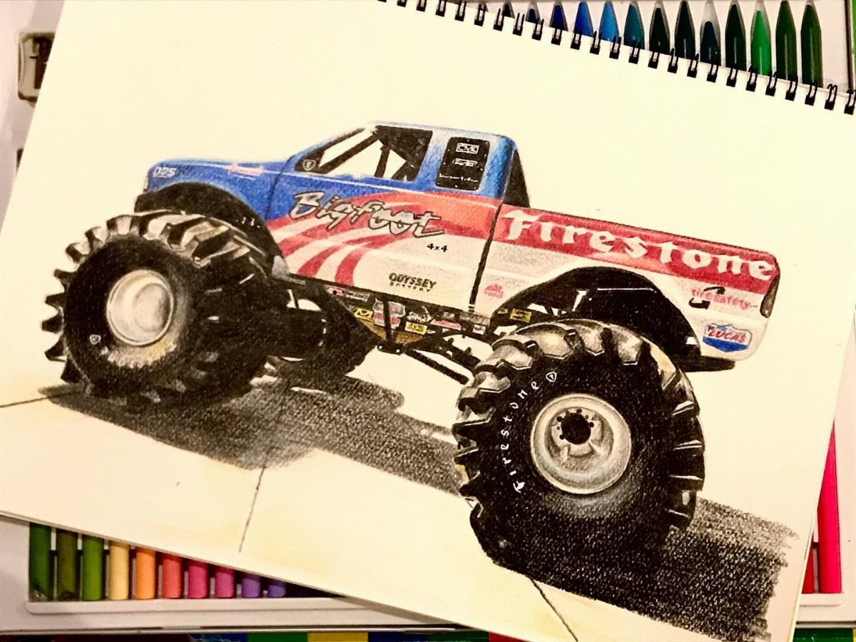 A colored pencil drawing of a Bigfoot monster truck with large tires on a sketchbook.